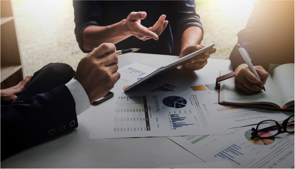 Business meeting with charts and tablet discussion.