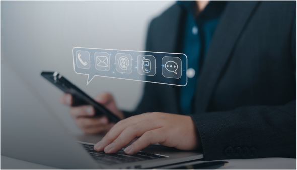 Person using smartphone and laptop for communication.